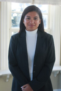 Woman standing in front of window.
