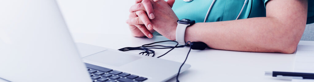 A laptop and a person's hands